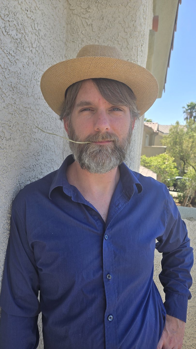 Troy in a blue shirt and straw hat