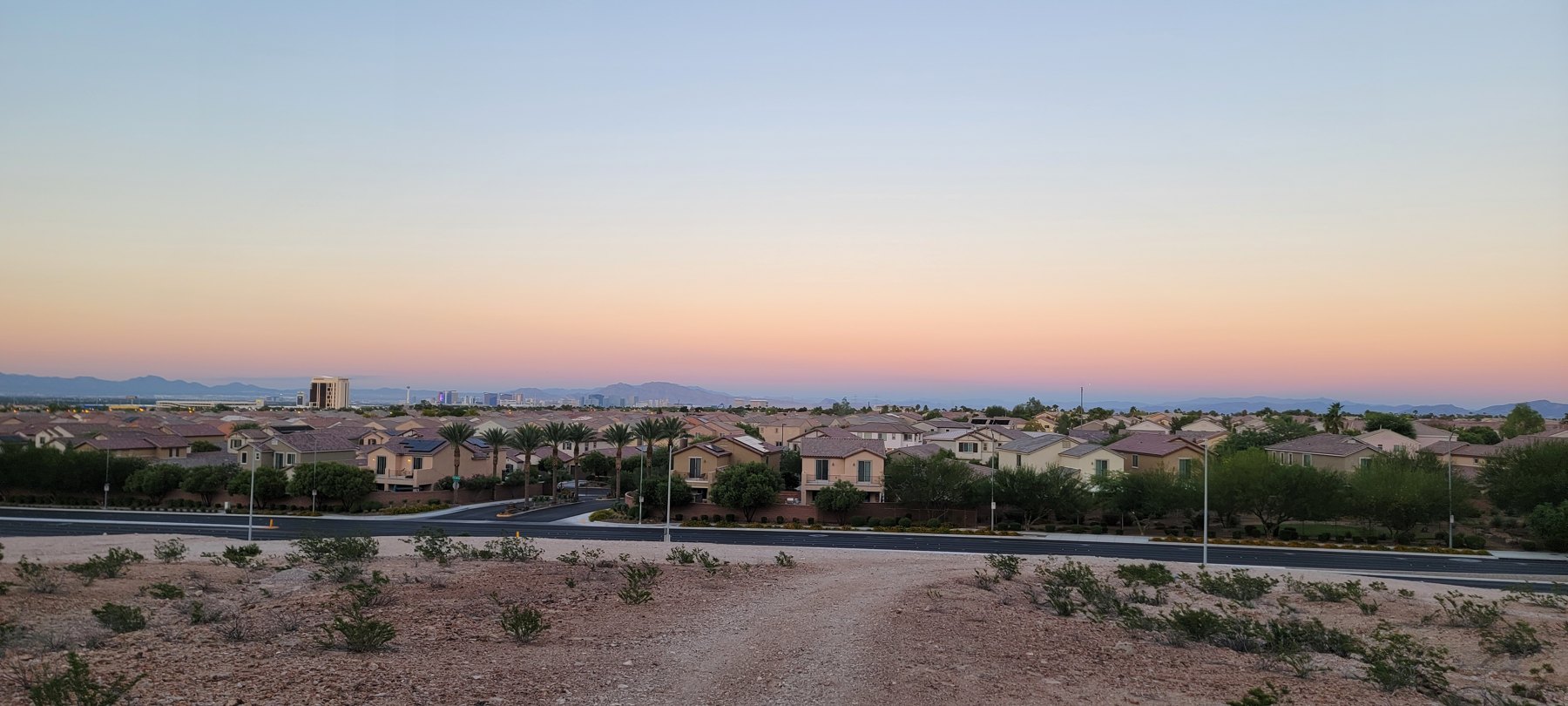 A wide view across Las Vegas toward the mountains at sunset
